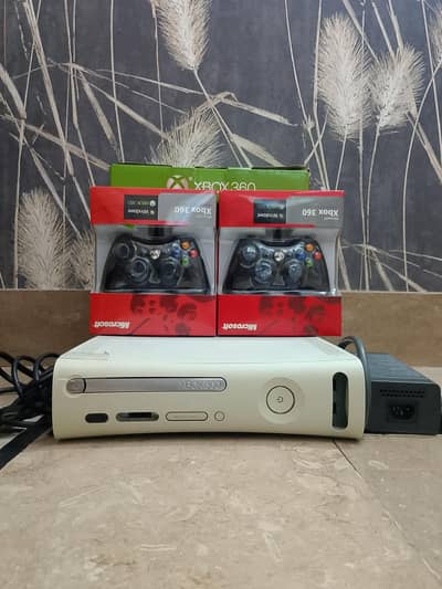 Xbox 360 with 2 wired box packed controllers or 320 GB hard. . .