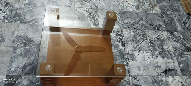 center wooden table with glass
