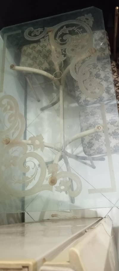 Glass top dining table with 6 iron rod chairs