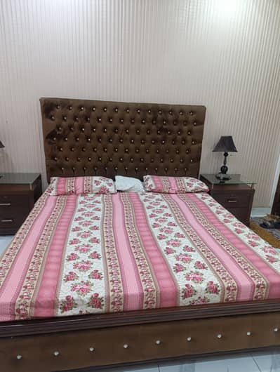 king size bed and two side tables with mattress
