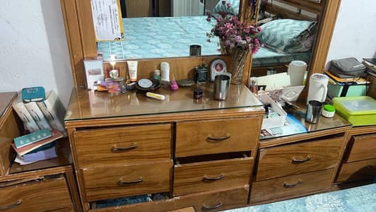 beautiful bed with installed lights ,side tables and dressing table.
