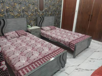Two twin single beds with two mattresses and one center table for sale