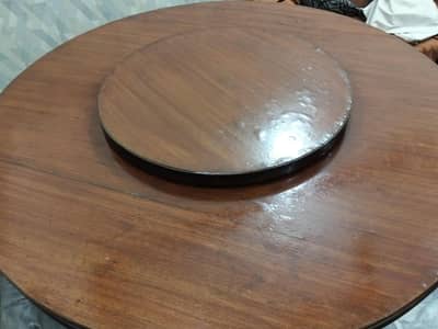 Revolving Dining table with 8 chairs. look like new.