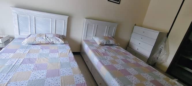 2 Single Beds with Storage underneath and a side table