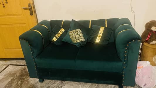 2 seater sofa in green color