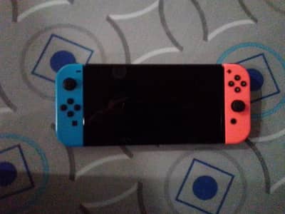 Nintendo Switch OLED + 2 Controllers + 5 Physical Games – Rs. 60,000