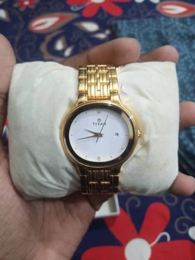 titan watch with box and book