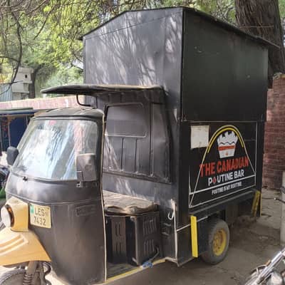 a three-wheeled rickshaw converted into a mobile food truck