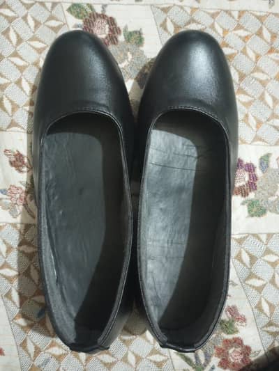 black synthetic leather flat slip-on shoes