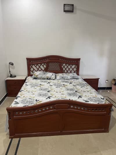 Wooden bed with side tables