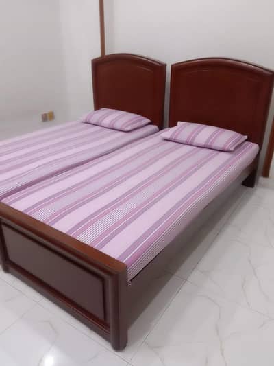 two single wooden beds