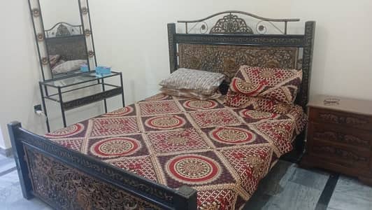 Iron bed with the dressing table with matrices with bed sheet