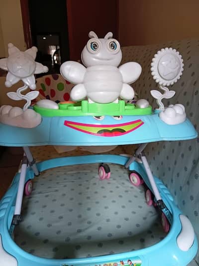 Baby walker blue colour with music light . Almost New