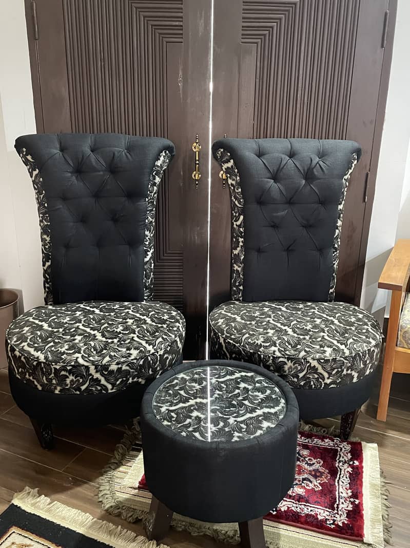 A pair of black high-back tufted accent/Sofa chairs with table 0