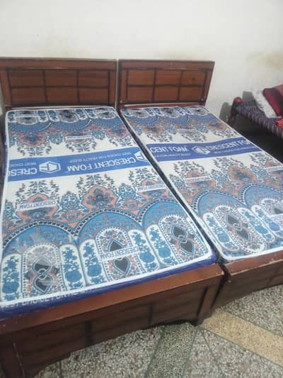 Two Wooden Single Beds with Mattresses.