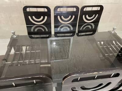 Dining table with glass top and 8 wood chairs with leather seats and