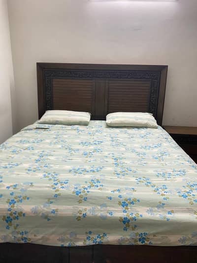 Queen size bed, side tables and dressing table.