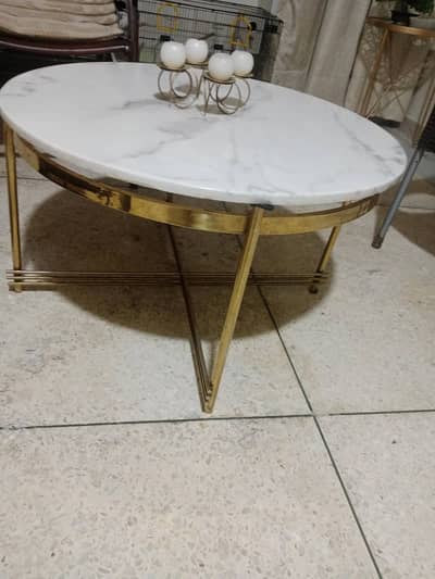Center table with brass frame and heavy marble on it