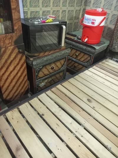 wooden bed with side table