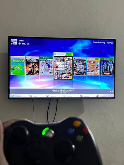xbox360 slim with games and controller