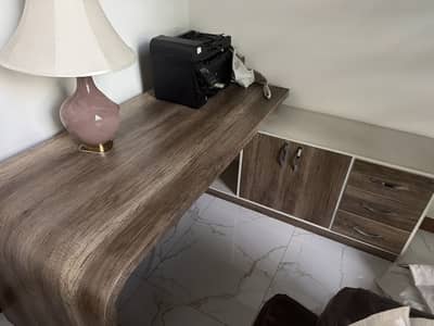 Brand new table with multiple drawers and cabinets.
