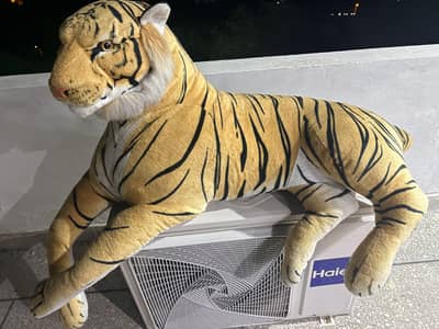 A large, realistic stuffed plush tiger toy