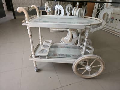 dinning table with tea trolly and cupboard