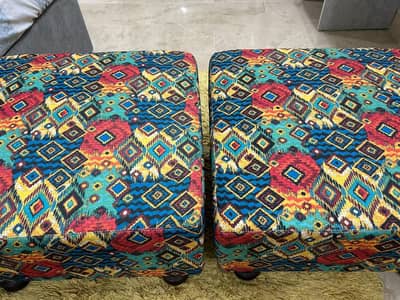 A pair of square shape stools for keeping in front of bed