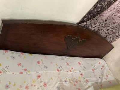 Wooden bed with mattress