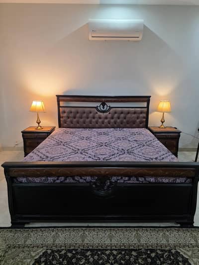 King size wooden bed with side tables