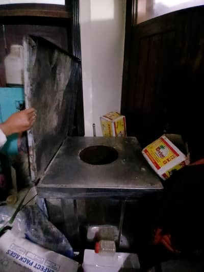 big commercial tandoor with stick
