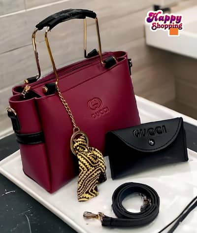 Maroon Rexine handbag set with wallet and strap.