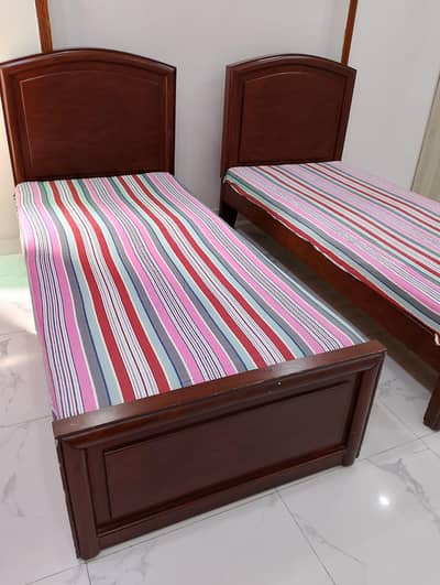 two single wooden beds