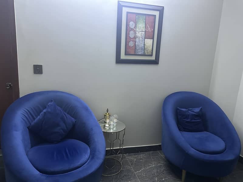 Blue colour sofas and small table 0