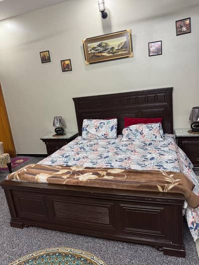 lavish bedroom with two side tables and included dressing table