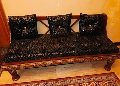 Beautiful carved wooden 3 seater sofa with cushions.