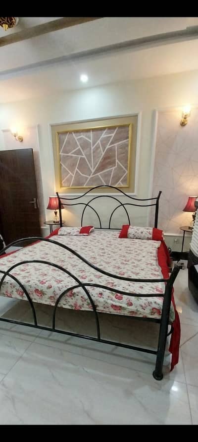 bed with 2 sidetables and a iron rack