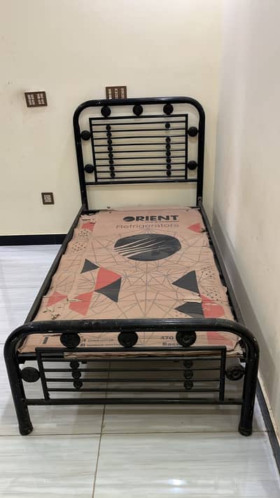 Iron single bed without mattress.