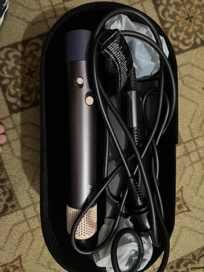 A partially used new dyson hair dryer and styler
