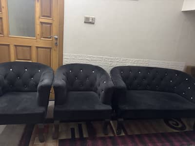 4 seater black velvet cushioning sofa