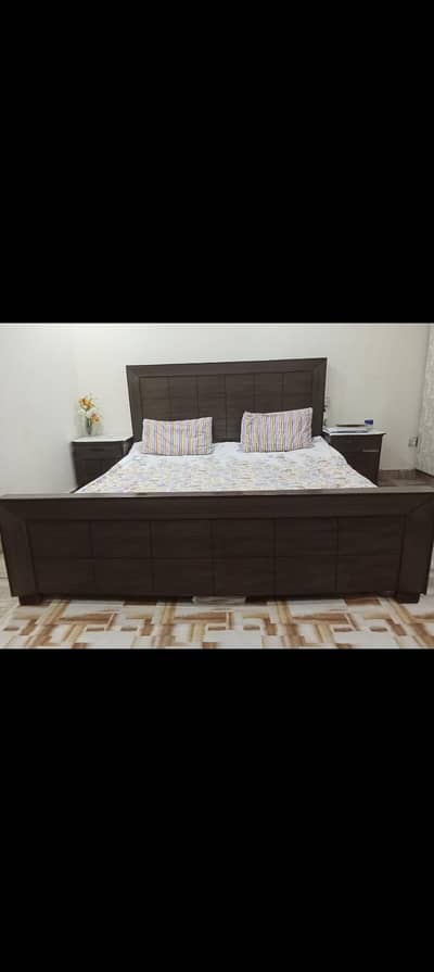 Big wooden Table, King size bed with side tables, and dressing Table