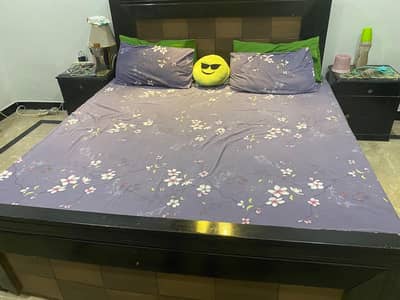 King size wooden bed with side tables