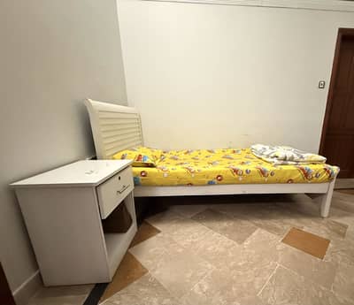 Single wooden bed with side table