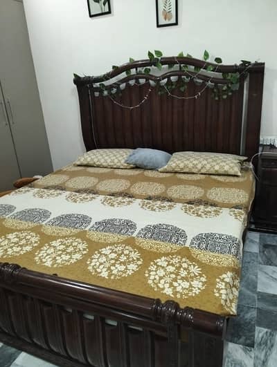 A magnificent king sized bed along with side table