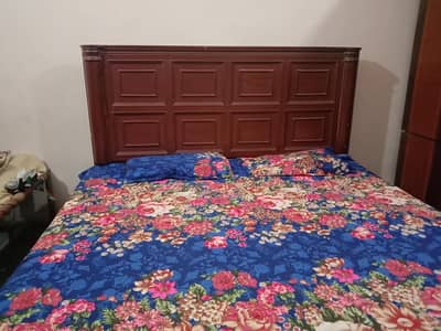 wooden bed with side table