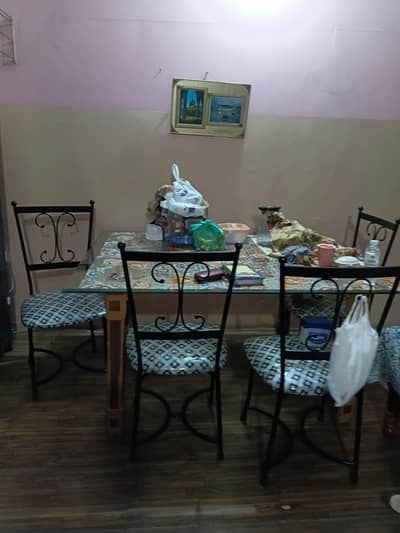 A glass table with 4 chairs