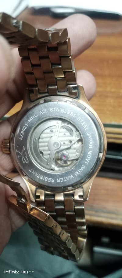 ak original American watch with green dail and golden chain