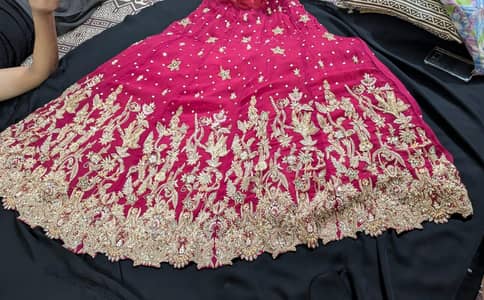Deep red hand embroided bridal lehnga with potli