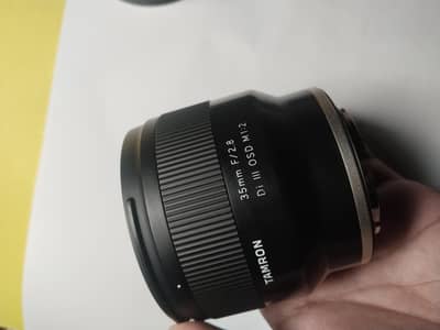 Sony lens 50mm 1.8 or Tamron 35 mm 2.8 lens
