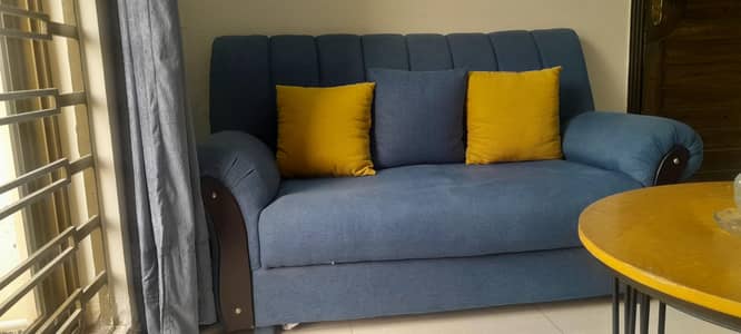 beautiful blue sofa with a hint of mustard and yellow cushions